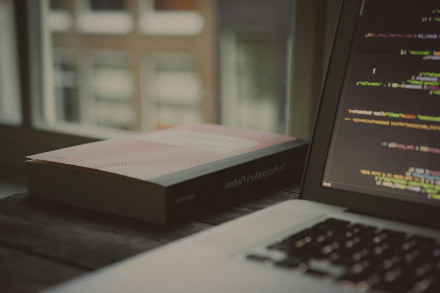 Student workspace with dual monitors showing 3D level editor and playtesting data